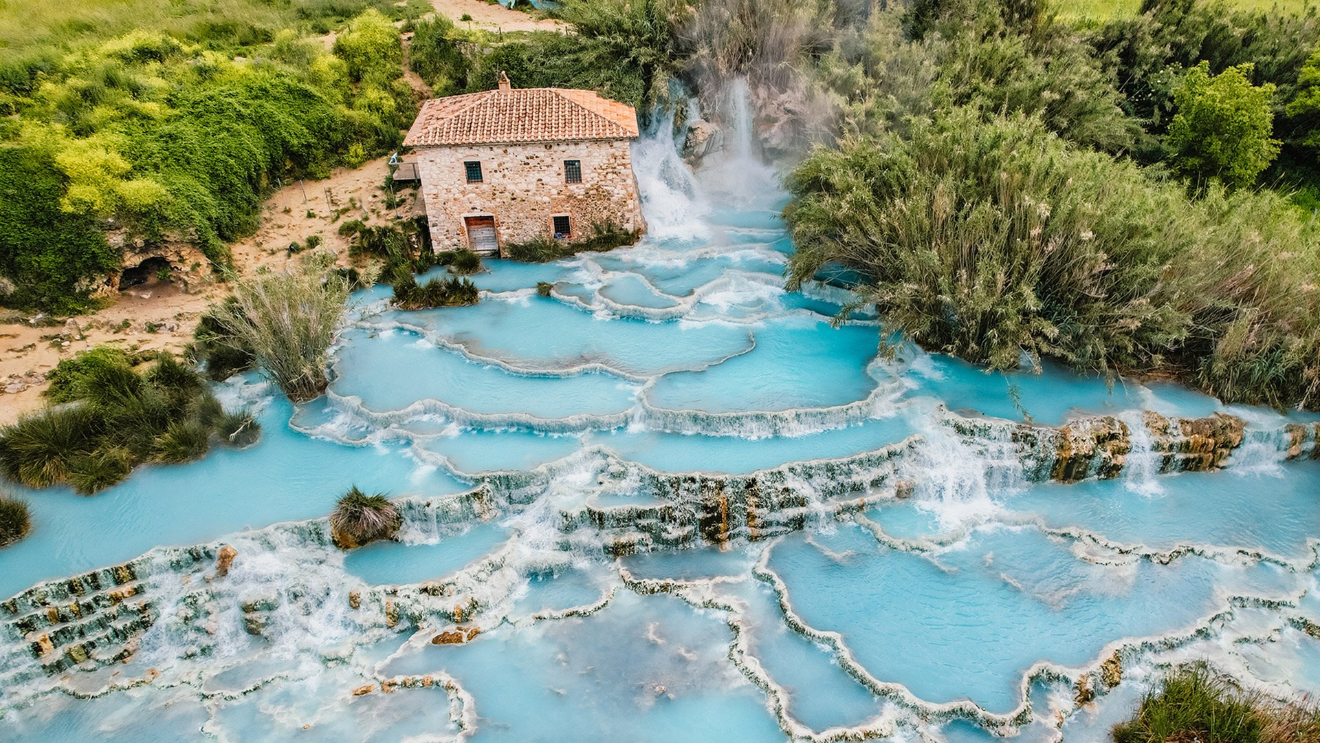 Toscane Italy, natural spa with waterfalls and hot springs at Saturnia thermal baths, Grosseto, Tuscany, Italy. Aerial view. Natural thermal waterfalls at Saturnia Toscany